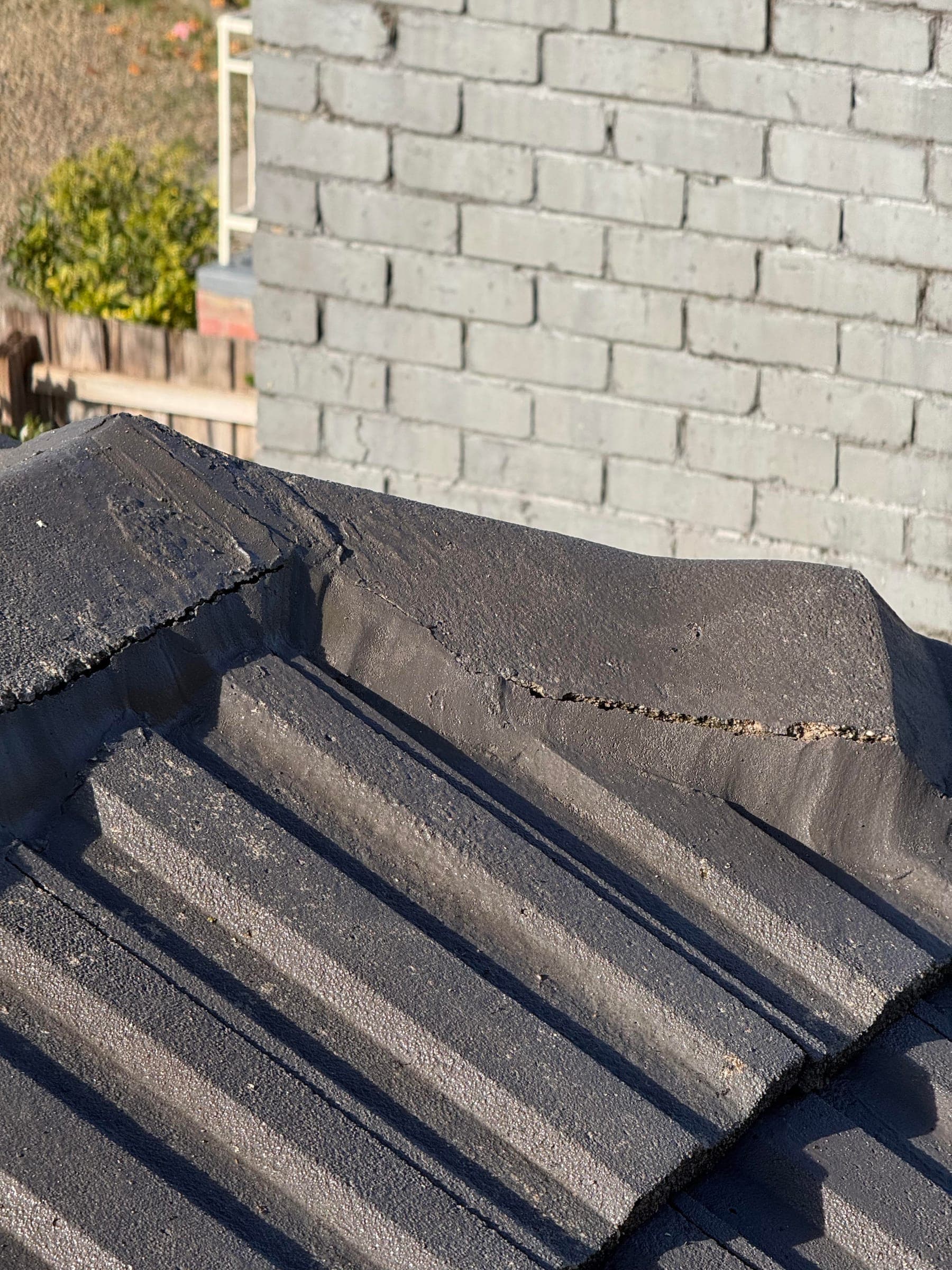 Cracked ridge pointing on a tiled roof, a common source of leaks