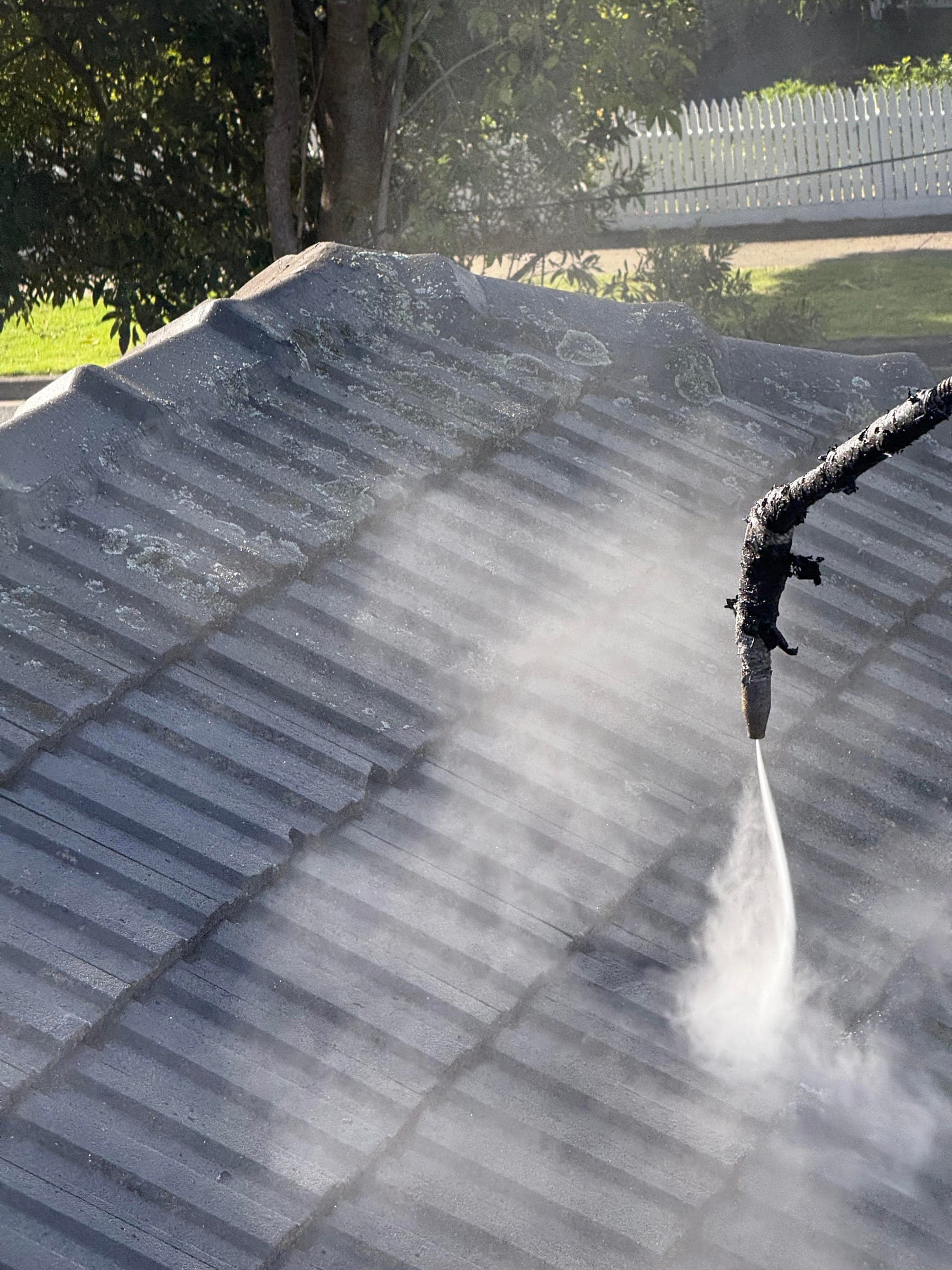 High-pressure cleaning a tiled Melbourne roof before recoating